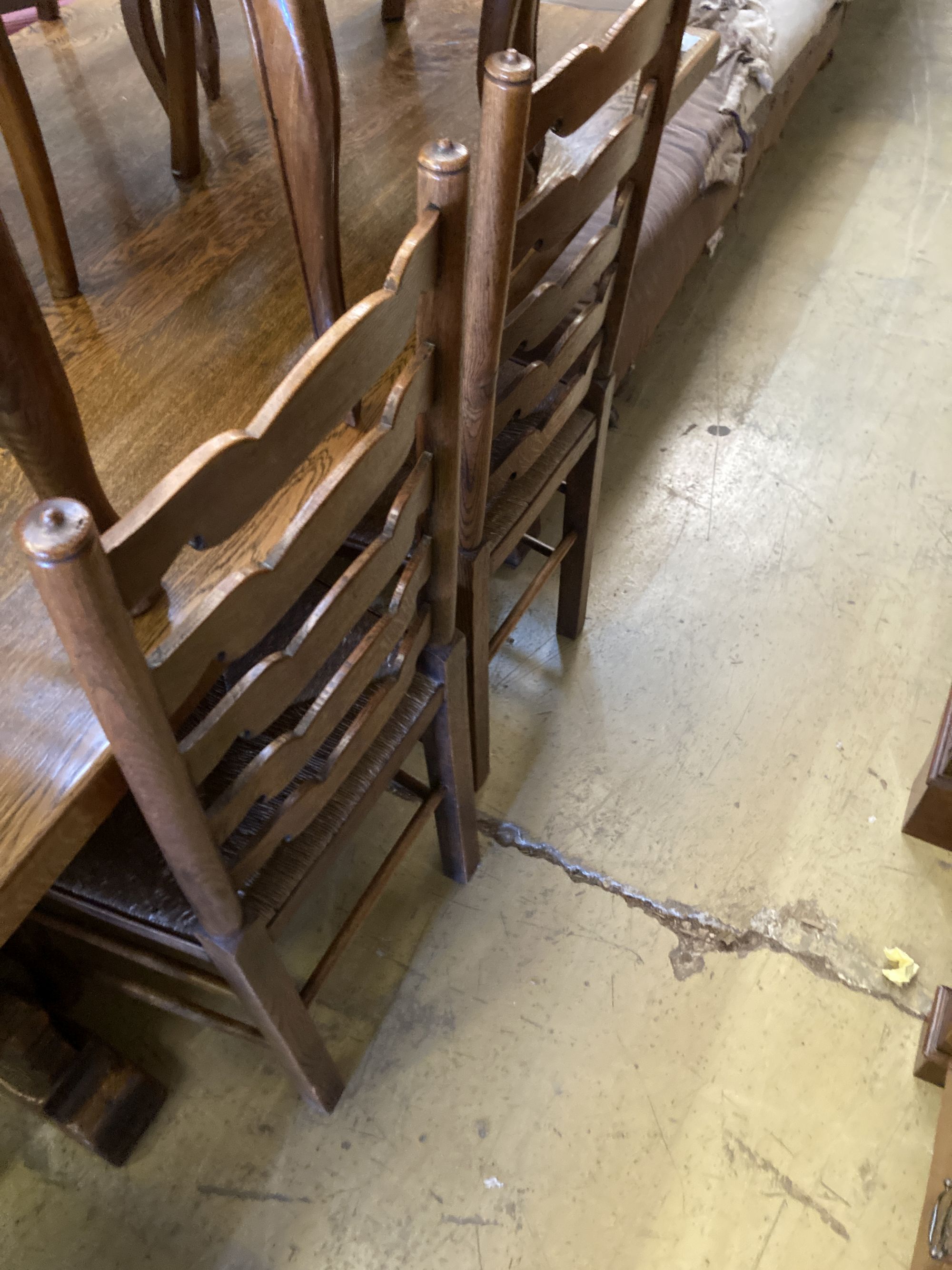 A set of six oak rush seated ladderback dining chairs